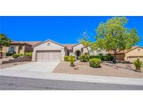 Single-story home with a two-car garage and desert landscaping at 2131 Sandstone Cliffs Dr, Henderson, NV 89044