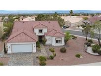 Charming single-story home featuring a red tile roof, stucco siding, desert landscaping, and a two-car garage at 2524 Banora Point Dr, Las Vegas, NV 89134