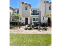 Two-story home boasts a private front patio, balcony, and a well-maintained lawn at 2620 Canary Yellow Ct, North Las Vegas, NV 89086