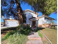 Two-story home with mature trees and lawn area, needs some TLC but has potential at 2784 Belcastro St, Las Vegas, NV 89117