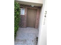 Inviting entryway with a classic brick facade and a well-maintained front door at 3412 Townhouse Dr, Las Vegas, NV 89121