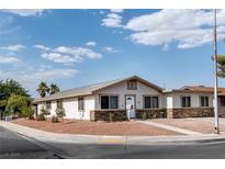 Charming single-story home featuring a landscaped front yard and a stone accent base at 4676 E Alexander Rd, Las Vegas, NV 89115