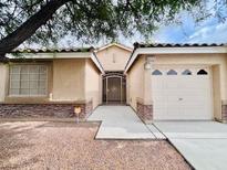Charming single-story home with a low maintenance landscape and a gated front entry at 4717 Mohawk River Ave, North Las Vegas, NV 89031