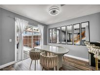 Bright dining room featuring wood floors, modern lighting, and sliding glass doors to the backyard at 5024 Starfinder Ave, Las Vegas, NV 89108