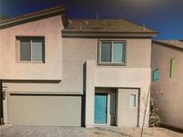 Two-story home boasts a modern design with a front-facing garage and a bright blue front door at 5888 Becklow Gardens Ave, Las Vegas, NV 89141