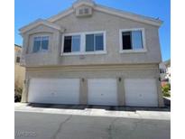 Three-story townhome featuring a stucco exterior and a three-car garage at 5969 High Steed St # 101, Henderson, NV 89011