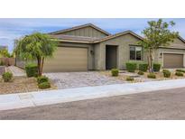 Charming single-story home featuring desert landscaping, a two-car garage and brick paved driveway at 6519 Summershade St, North Las Vegas, NV 89086