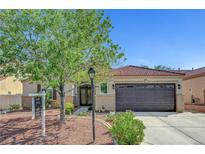 Charming single story home featuring a desert landscaped yard and decorative security screen door at 6647 Montezuma Castle Ln, North Las Vegas, NV 89084