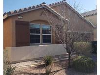 Charming single-story home featuring a neutral stucco exterior, complemented by a tile roof and a well-maintained front yard at 7112 Whitford St, Las Vegas, NV 89166