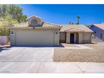 Charming single-story home featuring a two-car garage and desert landscaping for easy maintenance at 7713 White Grass Ave, Las Vegas, NV 89131