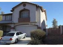 Charming two-story stucco home with a two car garage and tidy front yard at 780 Vortex Ave, Henderson, NV 89002
