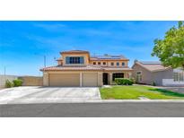 Charming two-story home featuring a tile roof, a spacious three-car garage, and manicured landscaping at 8914 Termoli St, Las Vegas, NV 89123