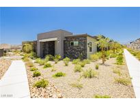 Charming single-story home with modern stone accents and desert landscaping at 901 Allister Fields Ln, Las Vegas, NV 89138
