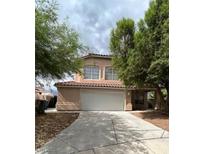 Charming home with a two-car garage, desert landscaping, and a red tile roof at 994 River Walk Ct, Henderson, NV 89015