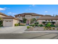Elegant two-story home boasting a circular entry, lush landscaping, and an attached three-car garage at 10829 Ickworth Ct, Las Vegas, NV 89135