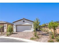 Charming single-story home featuring a brick driveway and a neutral-colored exterior with a two-car garage at 187 Palm Fox Ct, Henderson, NV 89011