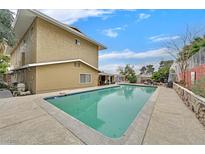 Large in-ground swimming pool perfect for relaxation and recreation surrounded by a concrete deck and mature trees at 1904 Chapman Dr, Las Vegas, NV 89104