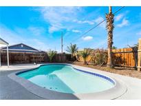Relaxing pool with clear blue water, surrounded by desert landscaping and bright sunshine at 2 Utah Way, Henderson, NV 89015