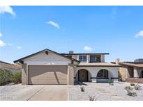 Inviting two-story home showcasing desert landscaping and a convenient two-car garage at 307 Balsa St, Henderson, NV 89002