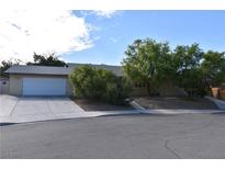 Charming single-story home with a well-manicured front yard, mature trees, and a two-car garage at 3633 Monte Verde St, Las Vegas, NV 89121