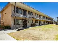 Charming two-story apartment complex featuring a well-maintained lawn and exterior stairs at 3718 Hazelwood St # 7, Las Vegas, NV 89119