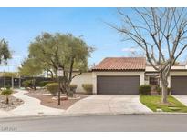 Single story home featuring desert landscaping, and a red tile roof, and two-car garage at 4687 Madreperla St, Las Vegas, NV 89121
