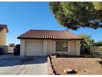 Charming single-story home featuring a red-tiled roof, attached garage, and low-maintenance desert landscaping at 500 Prescott St, Las Vegas, NV 89110