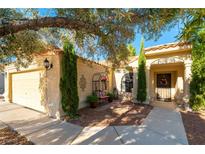 Charming single story home featuring desert landscaping, a covered front porch, and a two-car garage at 5104 Drummond Rd, Las Vegas, NV 89130