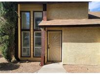 A townhome with a unique security door, large windows, and xeriscape at 513 Kristin Ln, Henderson, NV 89011