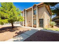 Charming multi-level home featuring a stucco exterior, arched window details and secure gated entry at 605 S Royal Crest Cir # 9, Las Vegas, NV 89169
