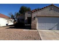 Charming single-story home featuring a desert landscape and a two-car garage at 733 Hitchen Post Dr, Henderson, NV 89011