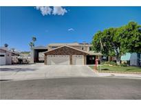 Charming two-story home featuring a three-car garage and mature landscaping at 902 Dianne Dr, Boulder City, NV 89005