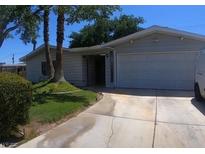 Charming single-story home featuring a two-car garage and a well-maintained, partially shaded front yard at 912 Saylor Way, Las Vegas, NV 89108