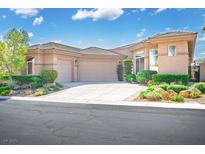 Charming single story home with a desert rock garden and a three car garage and well-maintained landscaping at 9233 Canyon Mesa Dr, Las Vegas, NV 89144