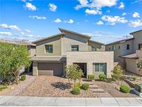 Two-story home featuring desert landscaping, a two-car garage, and a stylish exterior at 12415 Notch Trail Ave, Las Vegas, NV 89138