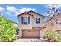 Charming two-story home featuring a well-manicured lawn, a two-car garage, and decorative shutters at 3741 Via Gaetano, Henderson, NV 89052