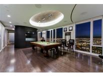 Elegant game room featuring a billiard table, hardwood floors, and expansive windows showcasing city views at 3750 S Las Vegas Blvd # 4507, Las Vegas, NV 89158