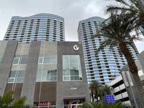 Luxury high-rise exterior with modern architecture and surrounding palm trees at 4575 Dean Martin Dr # 705, Las Vegas, NV 89103