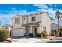 Charming two-story stucco home featuring a two-car garage and beautifully landscaped front yard at 7820 Esteem St, Las Vegas, NV 89131
