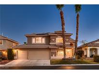 Charming two-story home boasts a three-car garage and desert landscaping at 9583 Gainey Ranch Ave, Las Vegas, NV 89147