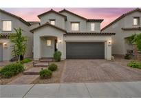 Two-story home features a tile roof, desert landscaping, and a two-car garage at 9947 Fletcher Peak Ave, Las Vegas, NV 89178