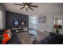 Stylish living room featuring a modern fireplace, mounted TV, and eye-catching decorative wall at 10628 Calf Creek Ct, Las Vegas, NV 89129