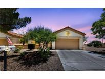 Charming single-story home with a well-maintained lawn, two-car garage, and a inviting front entrance at 1900 Bellview St, Las Vegas, NV 89134