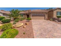Charming single-story home featuring a beautifully landscaped yard and brick paved driveway at 2398 Jada Dr, Henderson, NV 89044