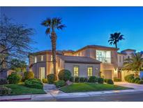 Elegant two-story home with mature landscaping, stucco exterior, and a private balcony at 2571 Red Springs Dr, Las Vegas, NV 89135