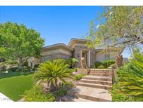 Stunning single-story home with stone accents, manicured lawn, and inviting landscaped entrance at 3048 Red Arrow Dr, Las Vegas, NV 89135