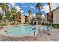 Community pool with palm trees, lounge chairs, and gazebo offer resort-style living at 4400 S Jones Blvd # 1125, Las Vegas, NV 89103