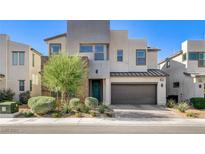 Stunning two-story home featuring modern architecture, a lush front yard, and a two car garage at 532 Monarch Ridge Ct, North Las Vegas, NV 89084