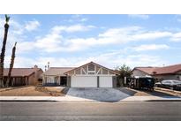 Charming single-story home with a two-car garage, desert landscaping, and a red-tiled roof at 5570 Palm St, Las Vegas, NV 89120