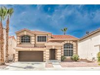 Charming two-story home with a red tile roof, two palm trees, and a two-car garage in a suburban neighborhood at 8737 Autumn Valley Ave, Las Vegas, NV 89129